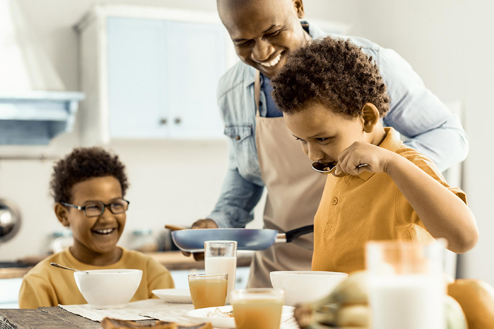 Family eating breakfast together in the kitchen