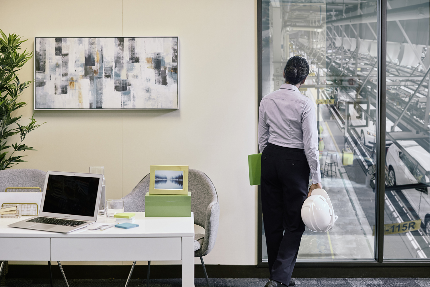 Manager overlooking manufacturing plant floor