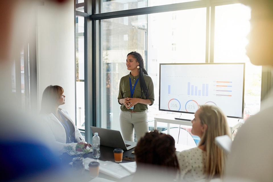 woman giving presentation to an engaged group of colleagues